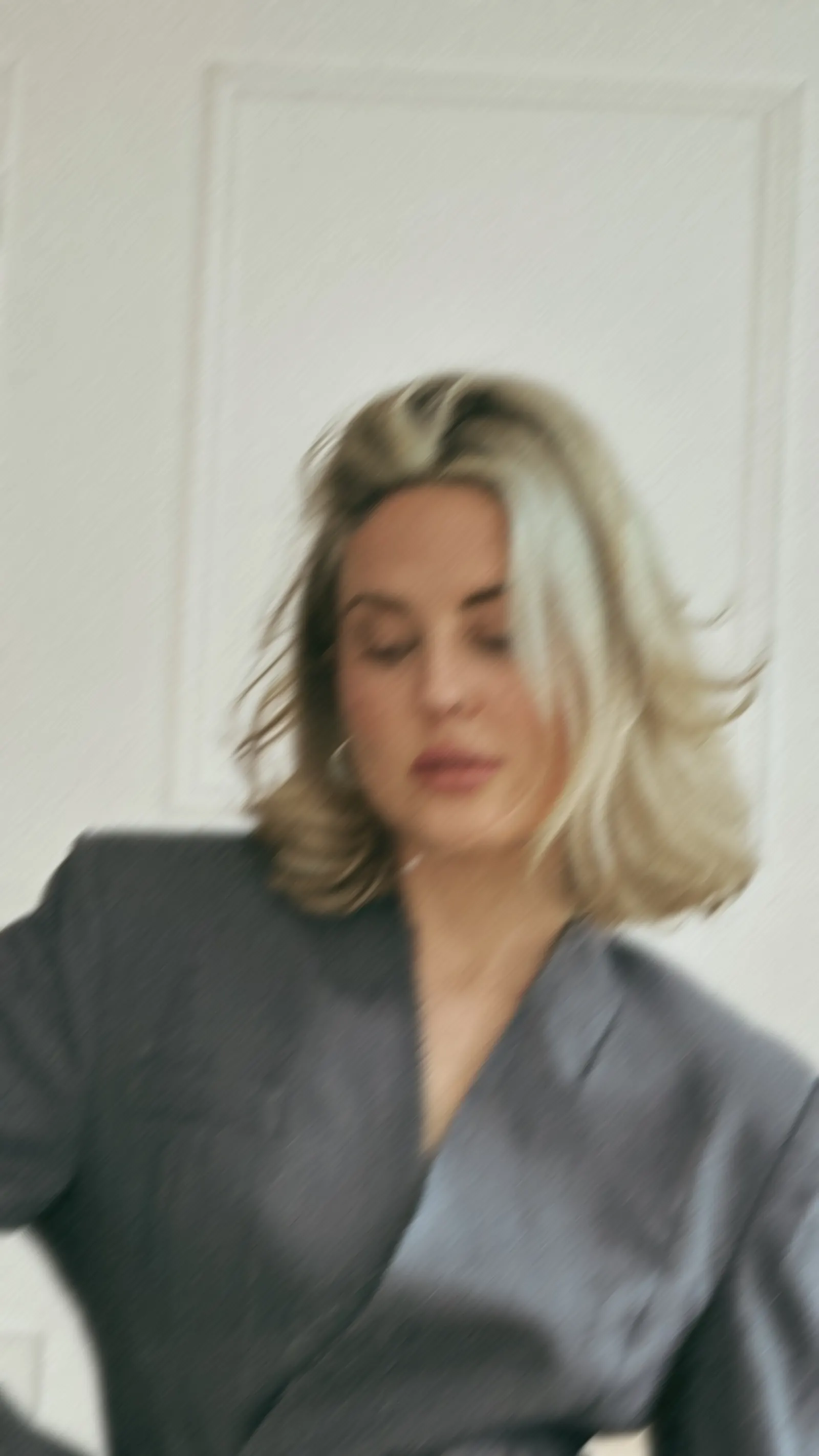 A soft-focus portrait of Emily in a grey blazer